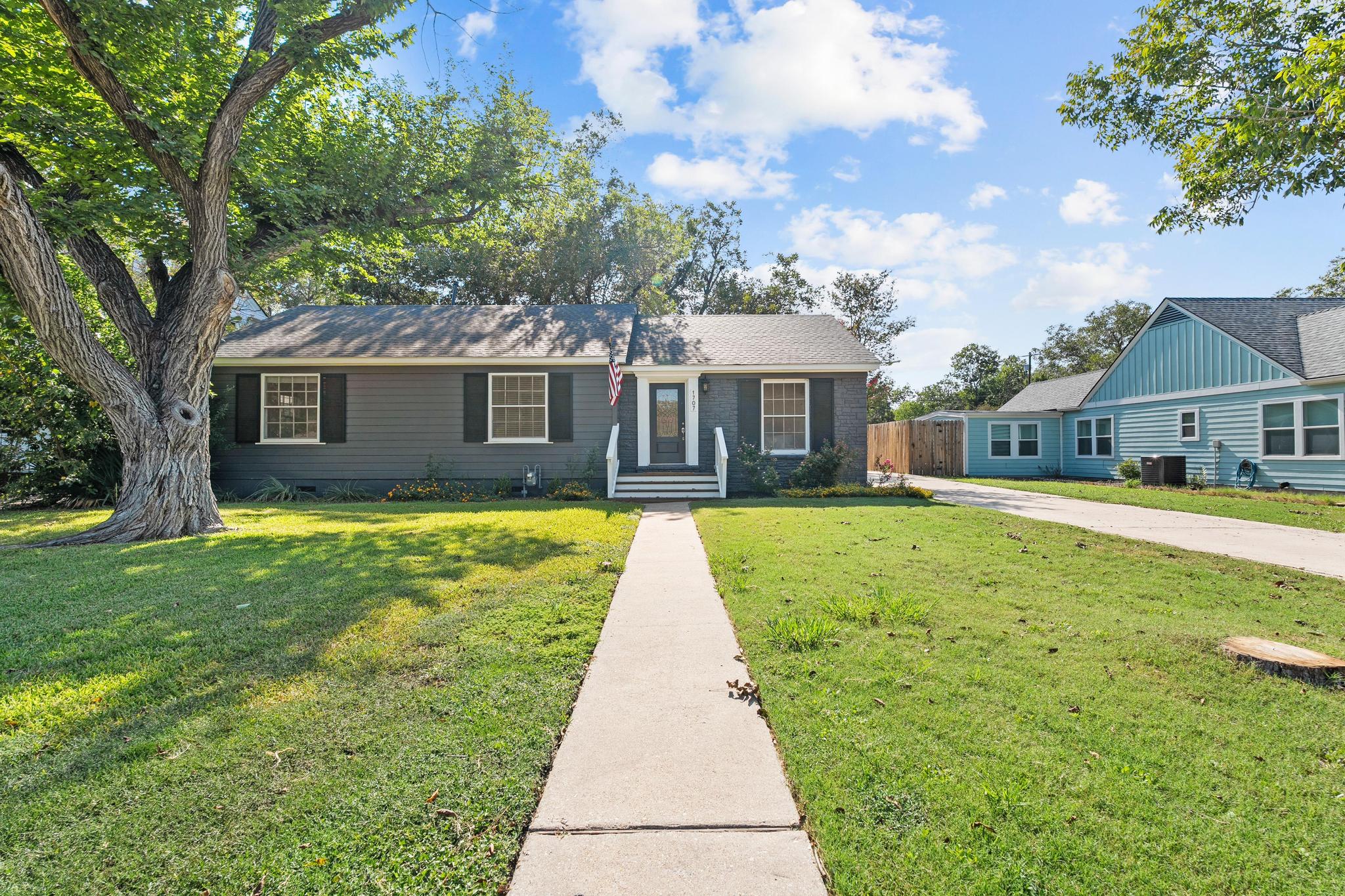 1707 Lexington Street Taylor, TX 76574 - Photo 2 of 29 a view of house with a garden