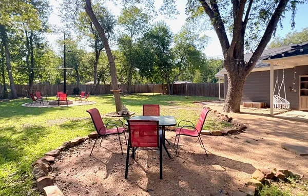 a view of a chairs and table in backyard of the house