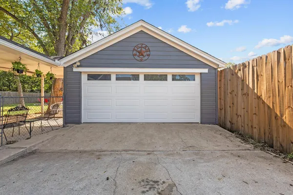 a front view of a house with a tree in it