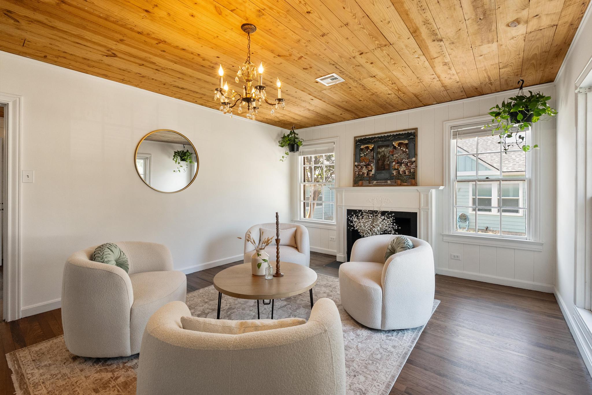 1707 Lexington Street Taylor, TX 76574 - Photo 3 of 29 a living room with furniture a fireplace and a chandelier