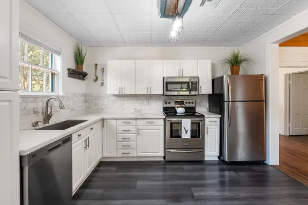 a kitchen with a refrigerator stove and sink
