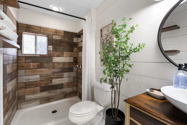 a bathroom with a toilet and a shower