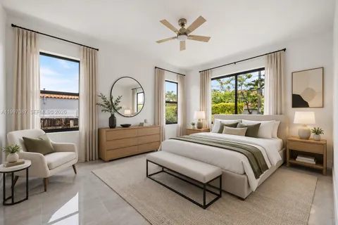 a spacious bedroom with a bed a couch and a window