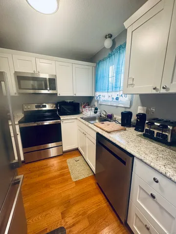 a kitchen with a sink a stove and cabinets