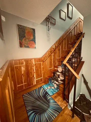 a view of entryway with stairs and wooden floor