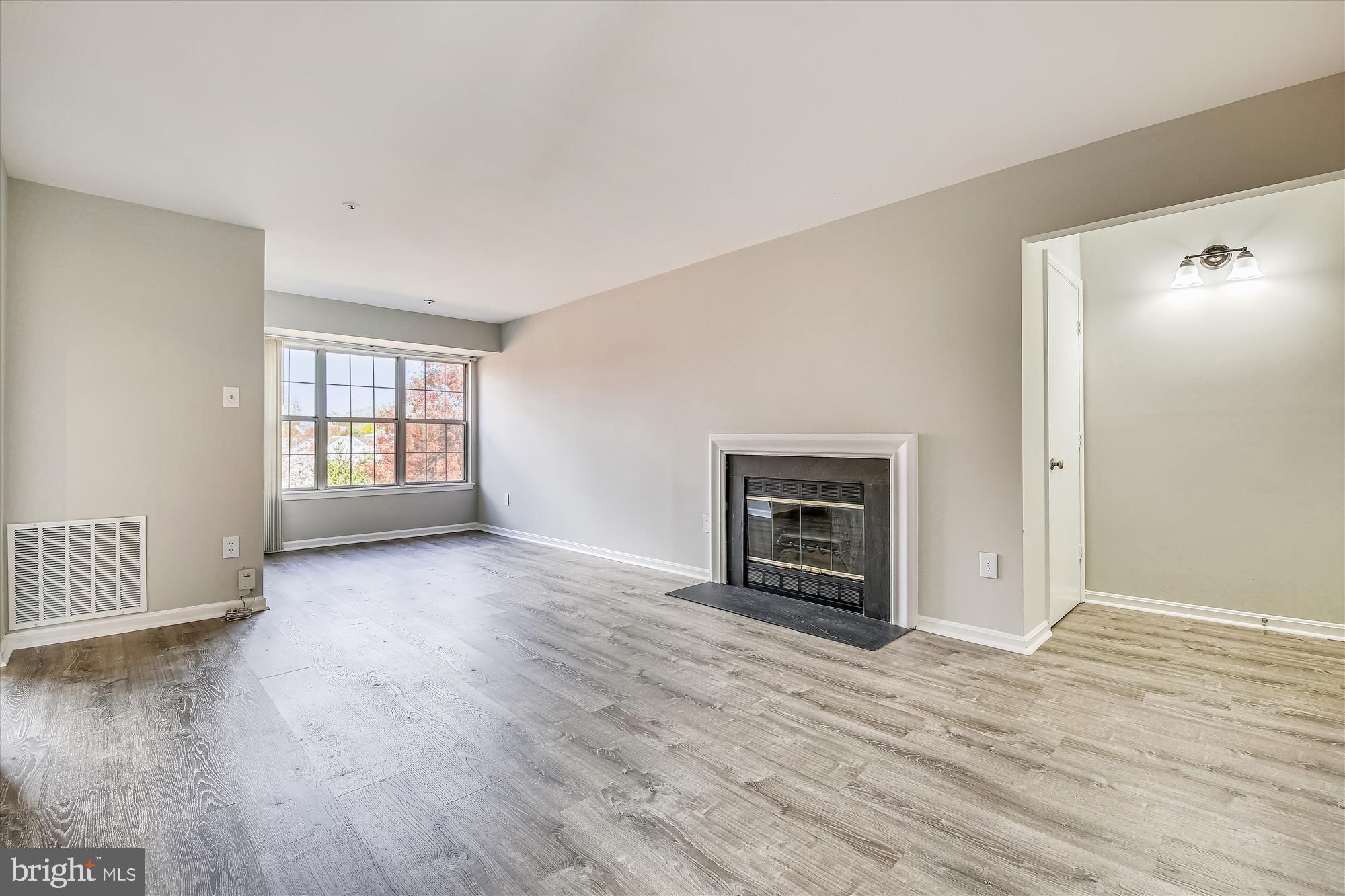 14902 McKisson Court, Unit 8BE Silver Spring, MD 20906 - Photo 4 of 38 Living Room includes wood burning fireplace