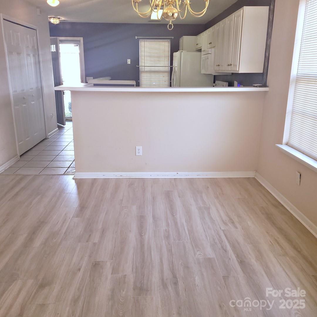 16740 Timber Crossing Road Charlotte, NC 28213 - Photo 3 of 7 a view of kitchen with furniture and wooden floor