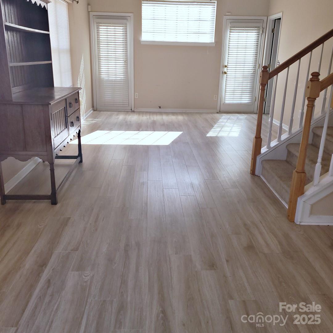 16740 Timber Crossing Road Charlotte, NC 28213 - Photo 4 of 7 an empty room with wooden floor and windows