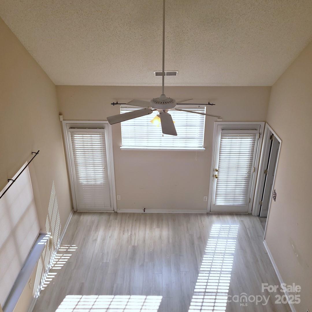 16740 Timber Crossing Road Charlotte, NC 28213 - Photo 7 of 7 an empty room with wooden floor and windows