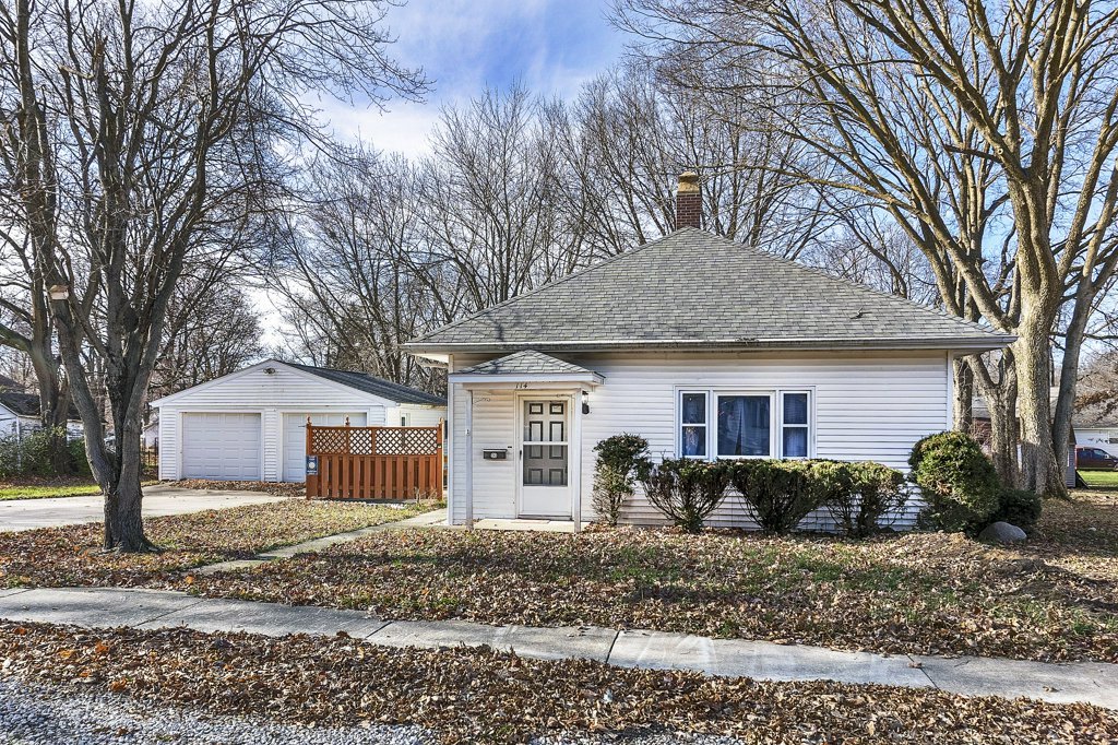a front view of house with yard and trees around