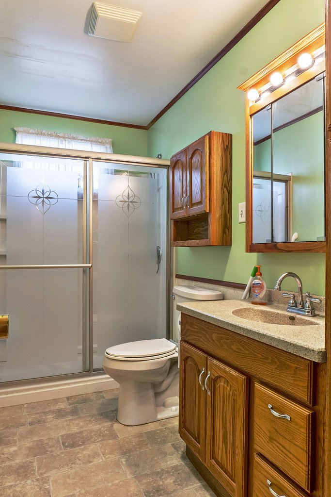 114 South Madison Street Saybrook, IL 61770 - Photo 18 of 31 a bathroom with a sink a toilet and a mirror