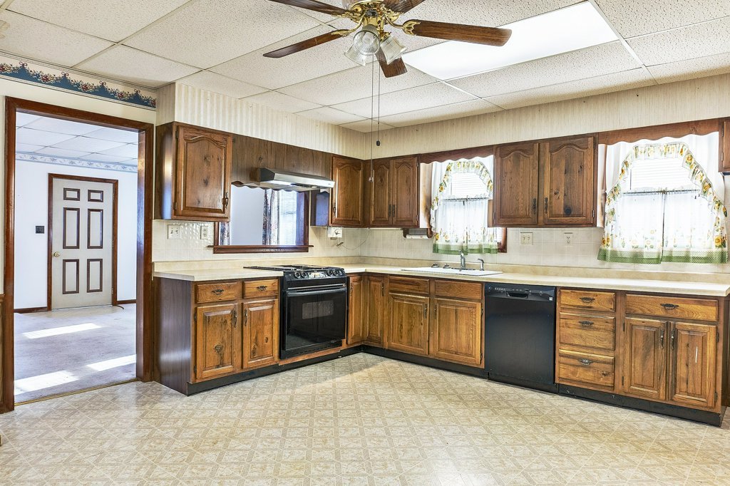 114 South Madison Street Saybrook, IL 61770 - Photo 6 of 31 a kitchen with granite countertop a stove cabinets and window