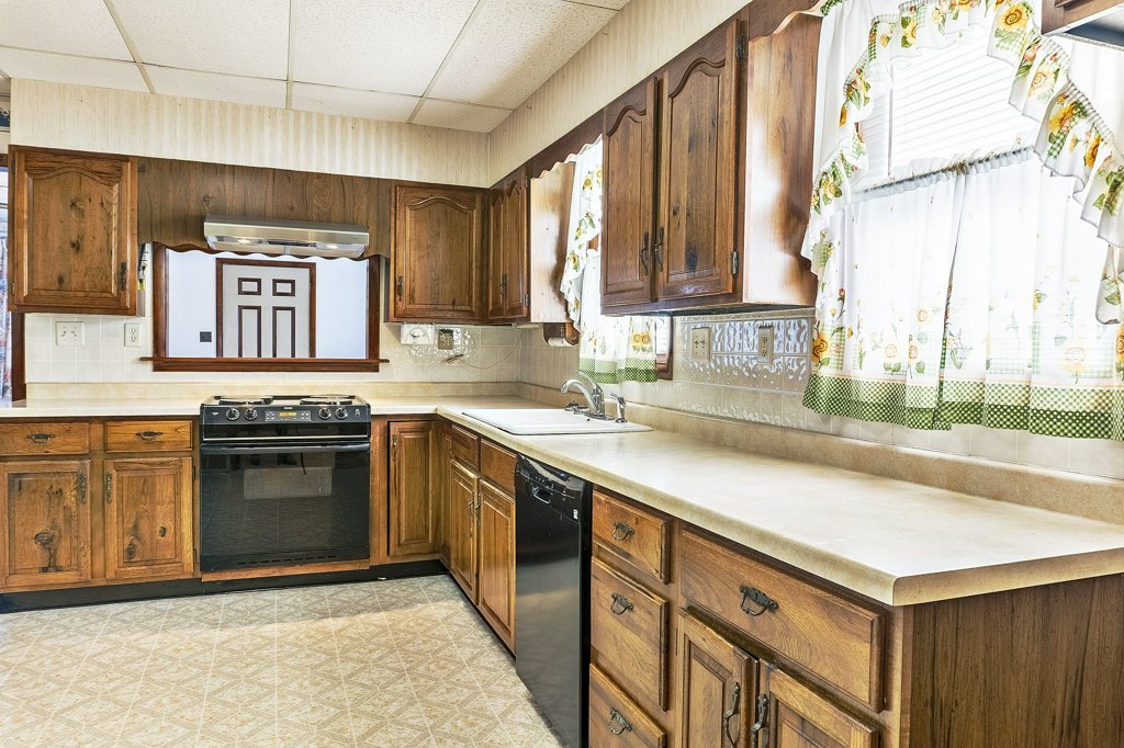 114 South Madison Street Saybrook, IL 61770 - Photo 7 of 31 a kitchen with stainless steel appliances granite countertop a sink and a stove