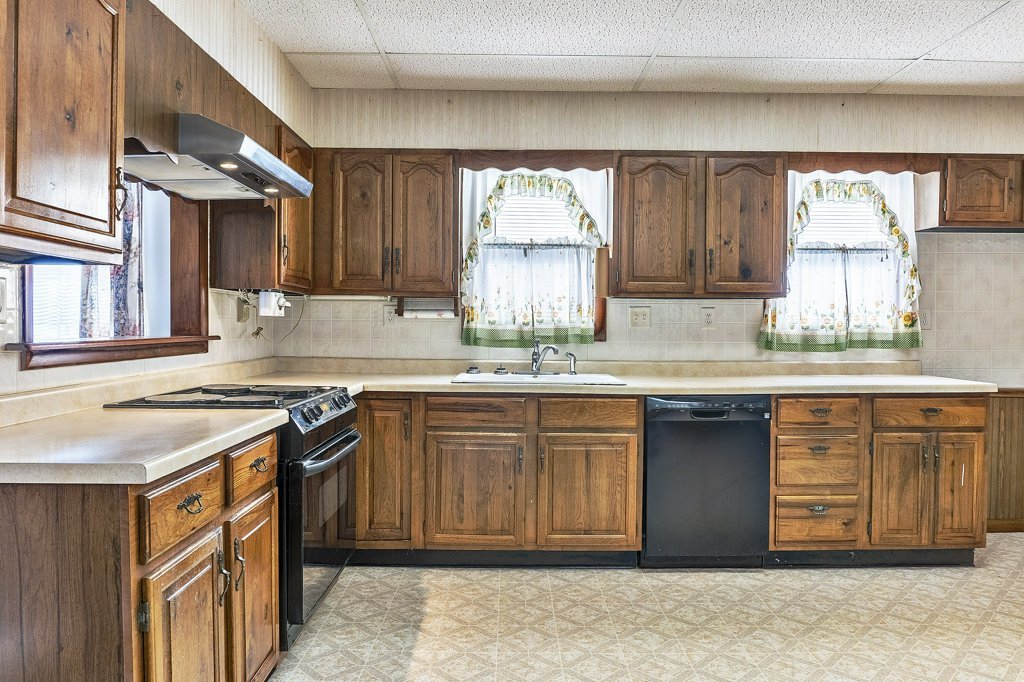 114 South Madison Street Saybrook, IL 61770 - Photo 8 of 31 a kitchen with stainless steel appliances granite countertop a sink stove and cabinets