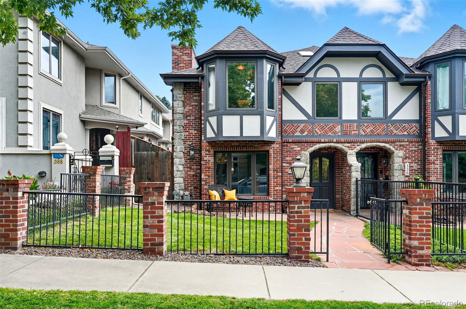 a front view of a house with a garden and plants