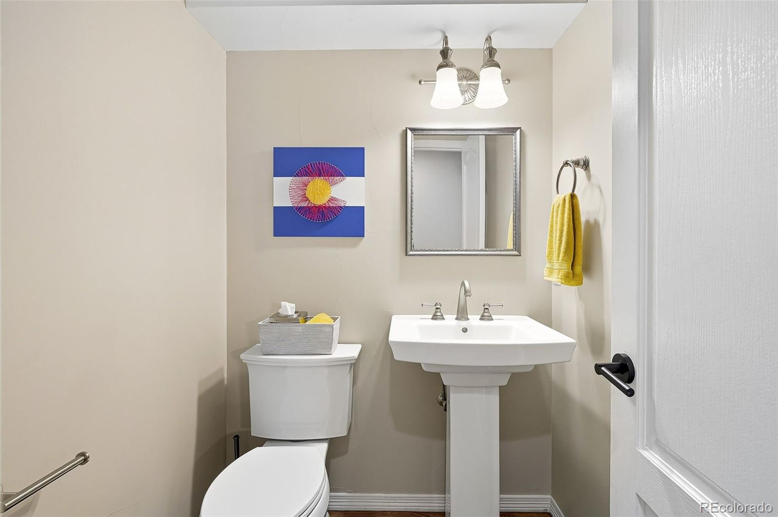 358 Steele Street Denver, CO 80206 - Photo 23 of 48 a bathroom with a sink mirror and toilet