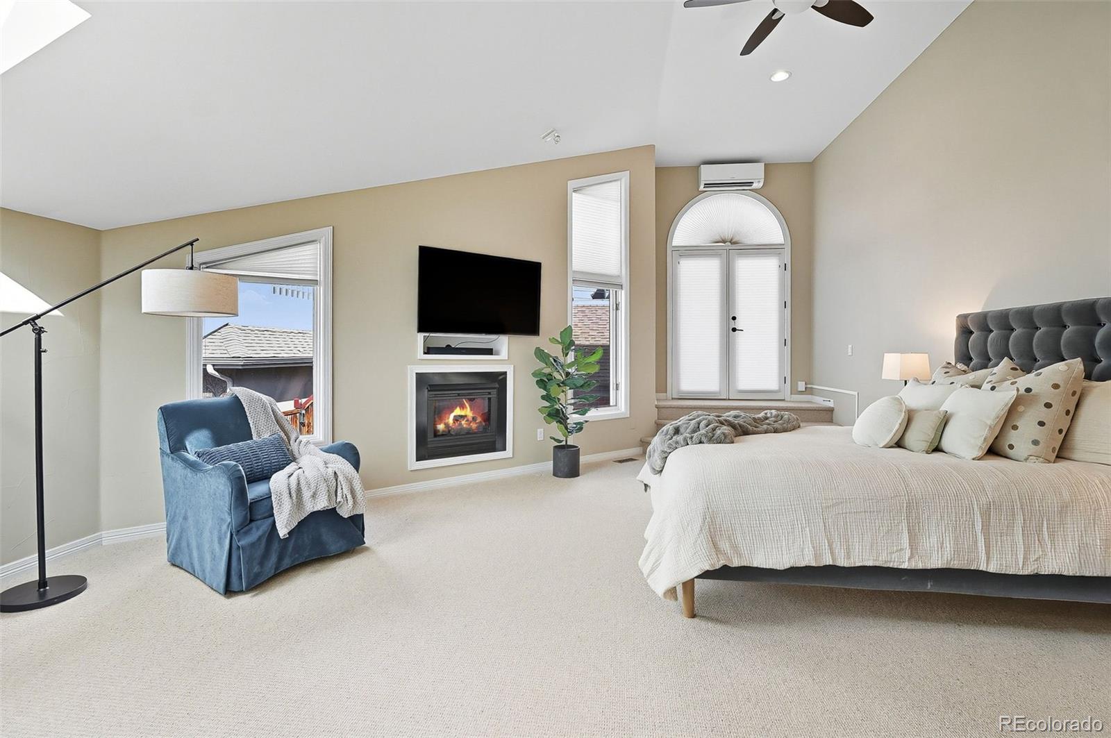 358 Steele Street Denver, CO 80206 - Photo 26 of 48 a spacious bedroom with a bed and a flat screen tv