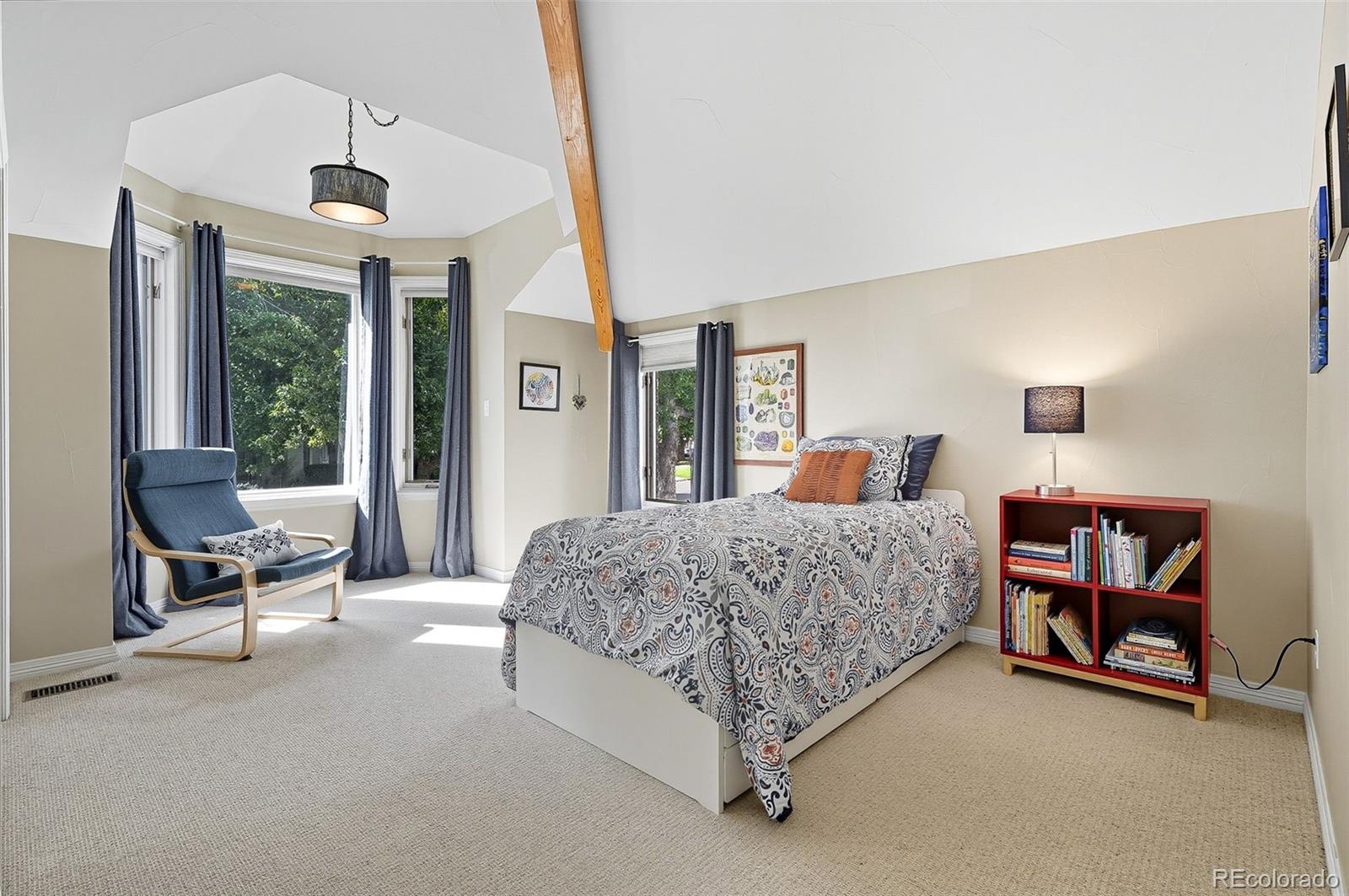 358 Steele Street Denver, CO 80206 - Photo 33 of 48 a bedroom with a large bed and a chandelier