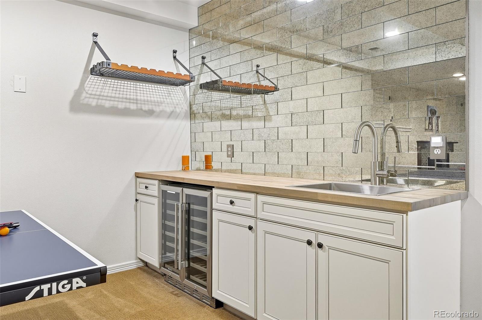 358 Steele Street Denver, CO 80206 - Photo 37 of 48 a kitchen with a sink and cabinets