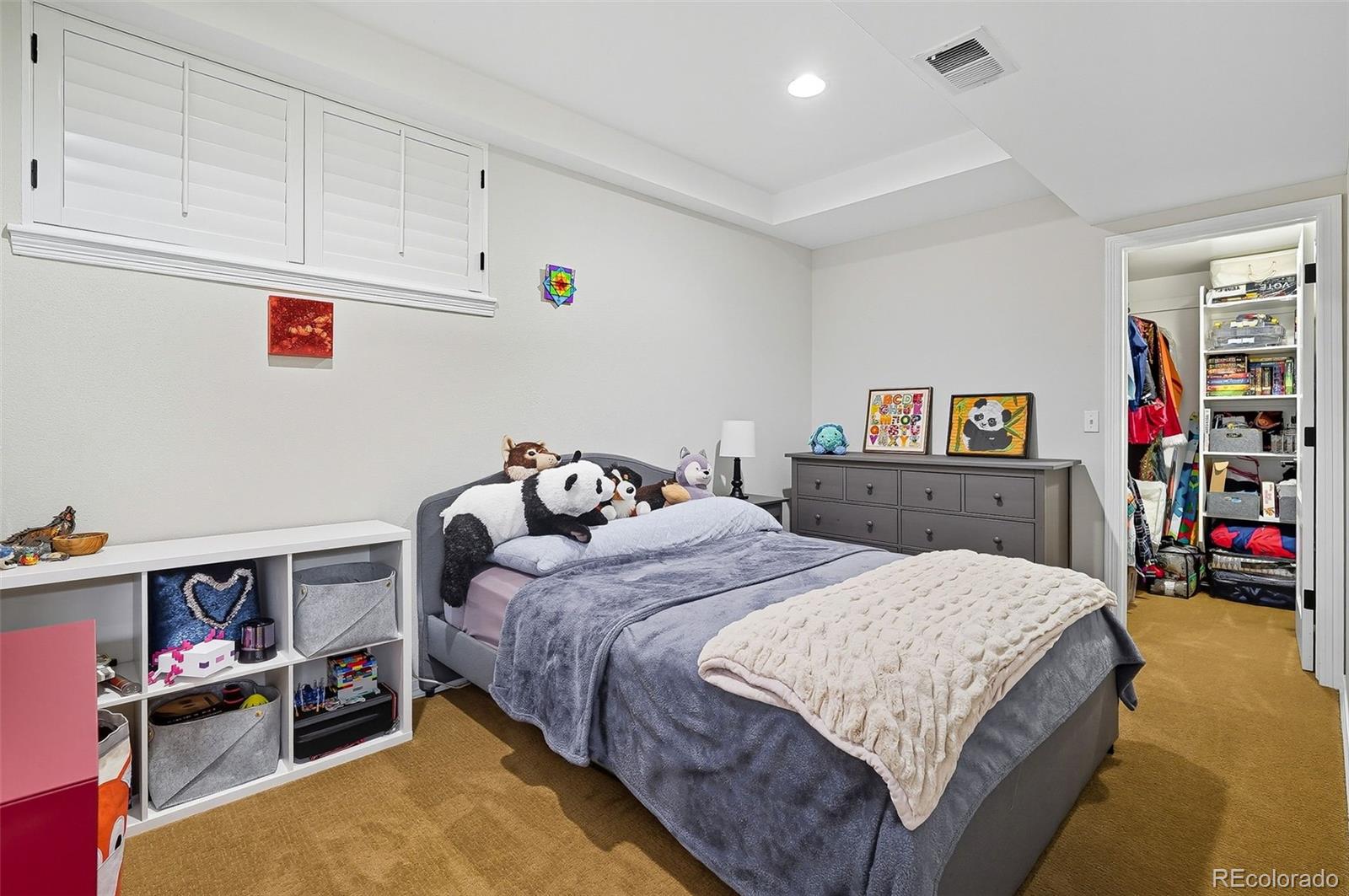 358 Steele Street Denver, CO 80206 - Photo 39 of 48 a bedroom with a bed and a book shelf