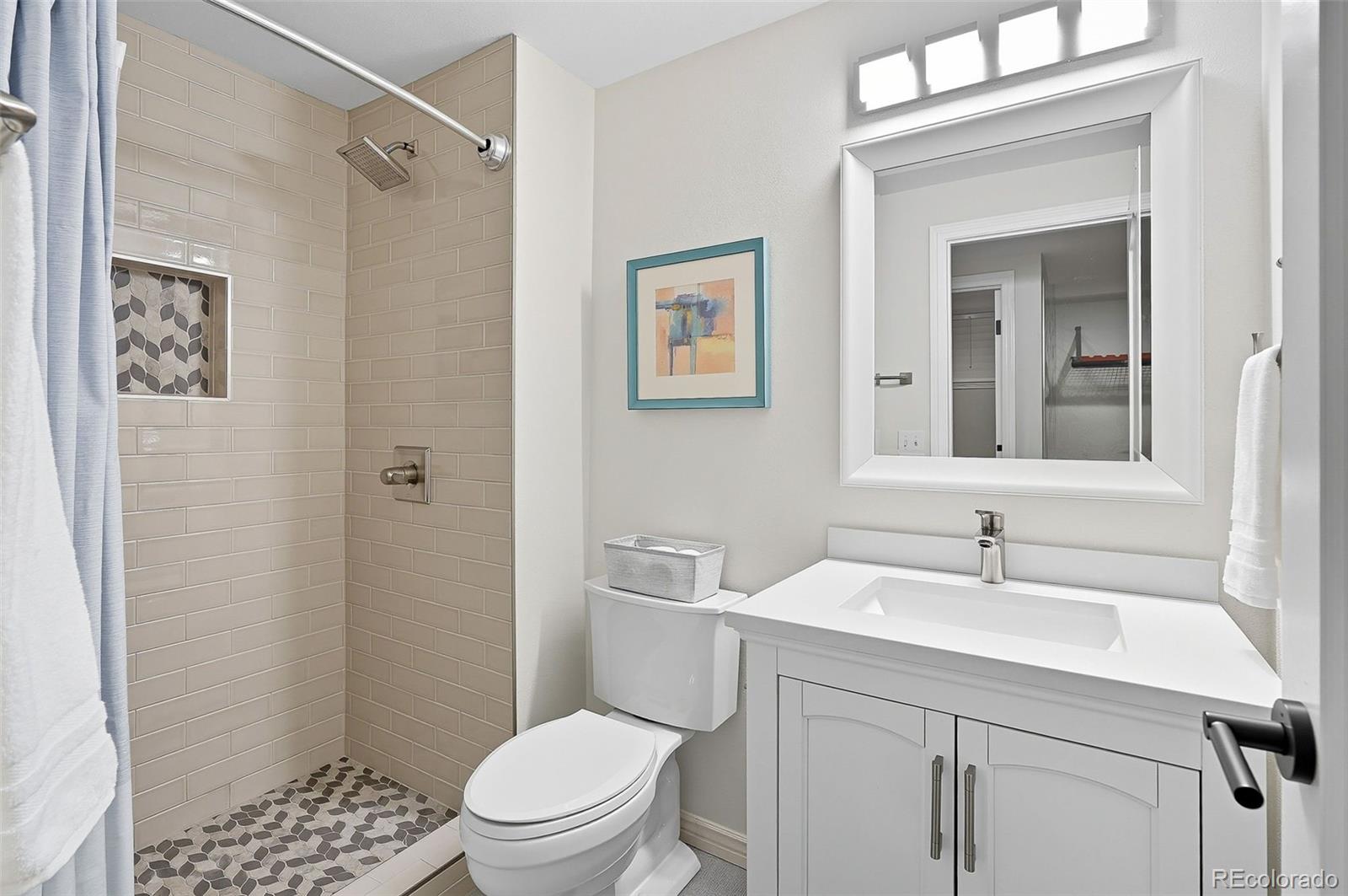 358 Steele Street Denver, CO 80206 - Photo 40 of 48 a bathroom with a sink a toilet and shower