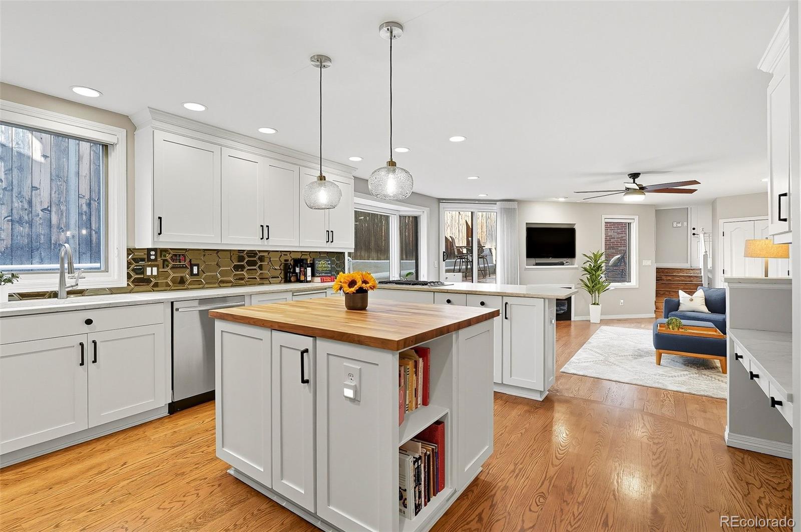 358 Steele Street Denver, CO 80206 - Photo 4 of 48 a kitchen with kitchen island granite countertop a sink appliances and cabinets