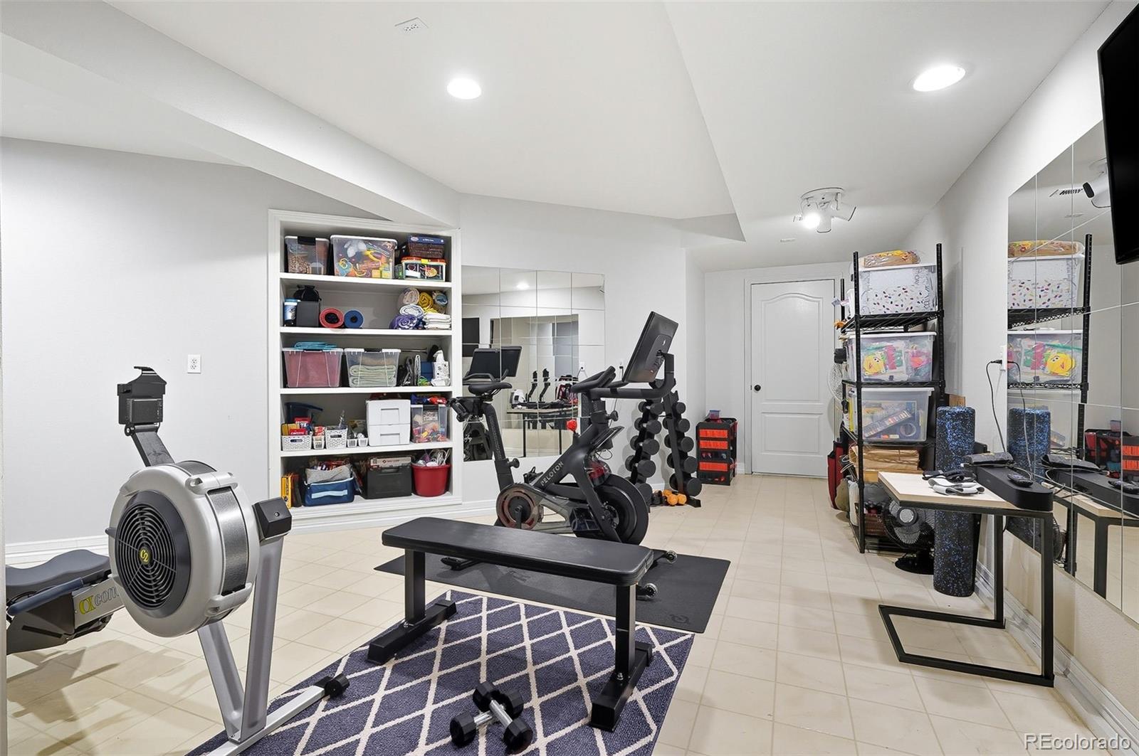 358 Steele Street Denver, CO 80206 - Photo 41 of 48 a view of a workspace with furniture and a book shelf
