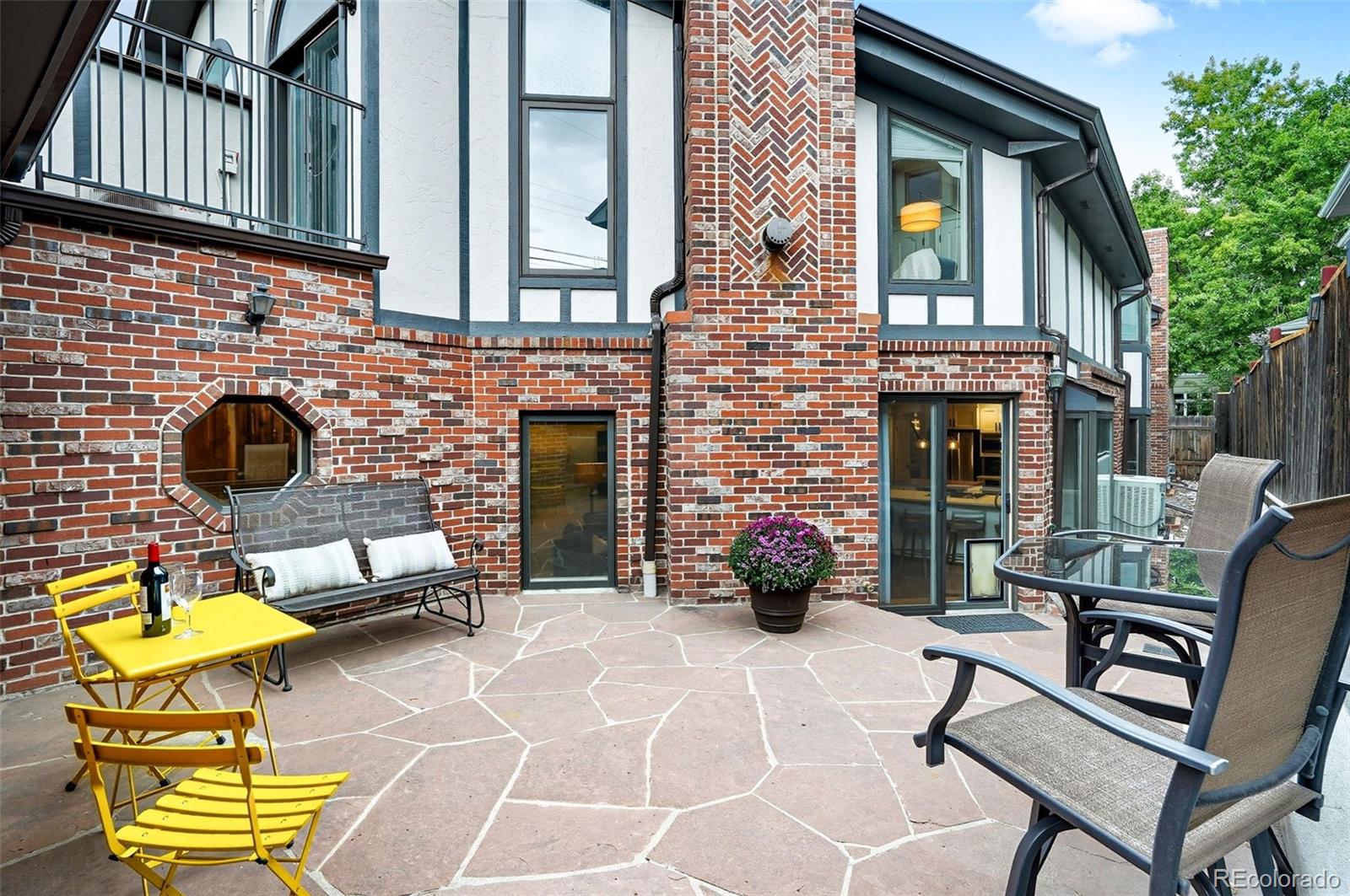 358 Steele Street Denver, CO 80206 - Photo 42 of 48 a view of a chairs and a table in the patio