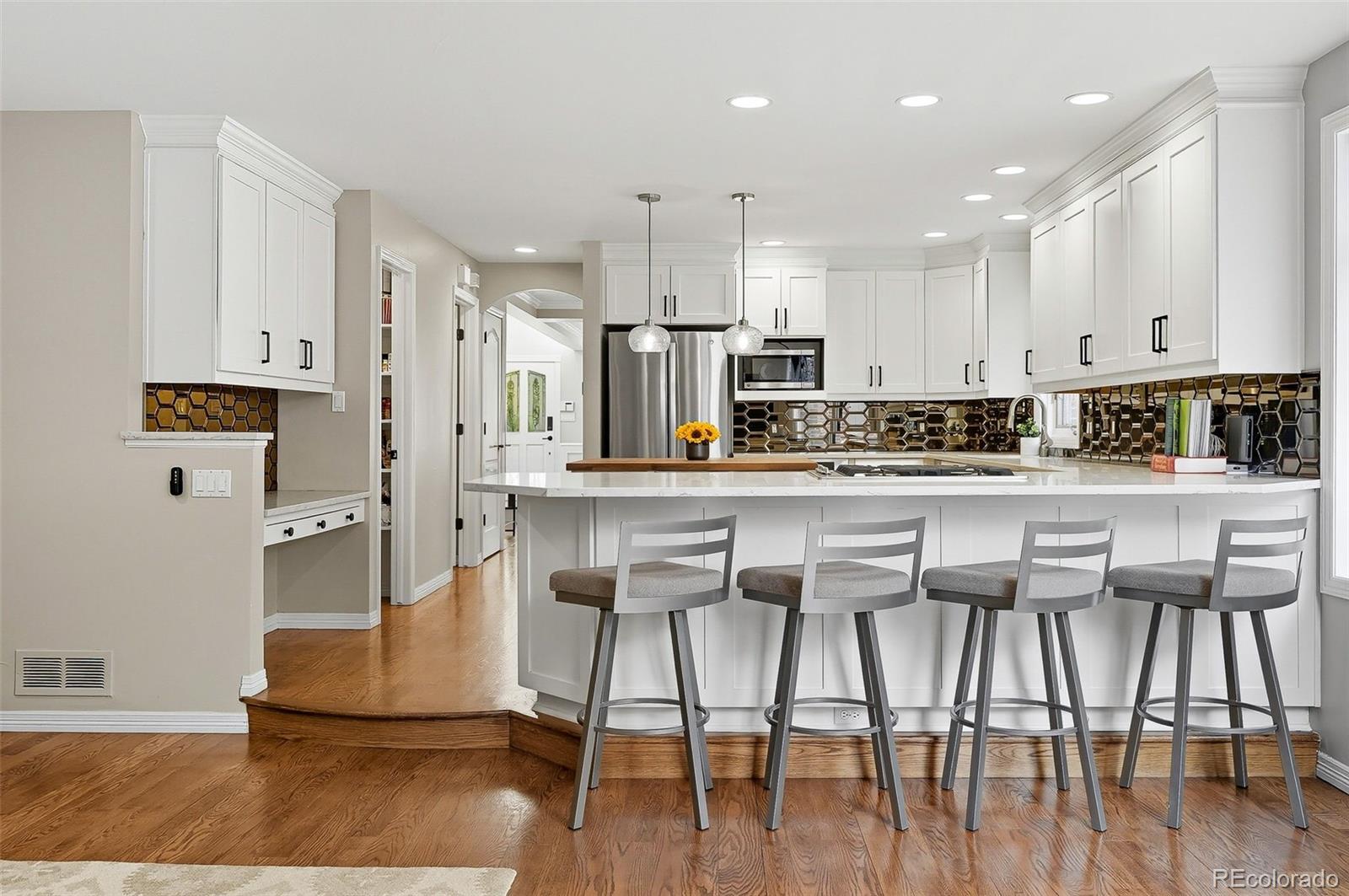 358 Steele Street Denver, CO 80206 - Photo 9 of 48 a kitchen with stainless steel appliances kitchen island granite countertop a refrigerator and a stove top oven