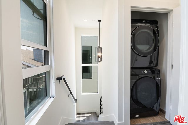 a view of a hallway with washer and dryer
