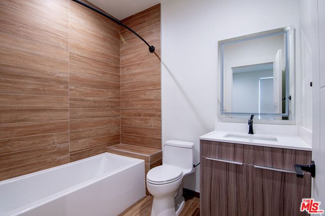 a bathroom with a sink a toilet and bathtub