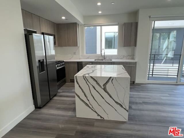a kitchen with a refrigerator and a sink