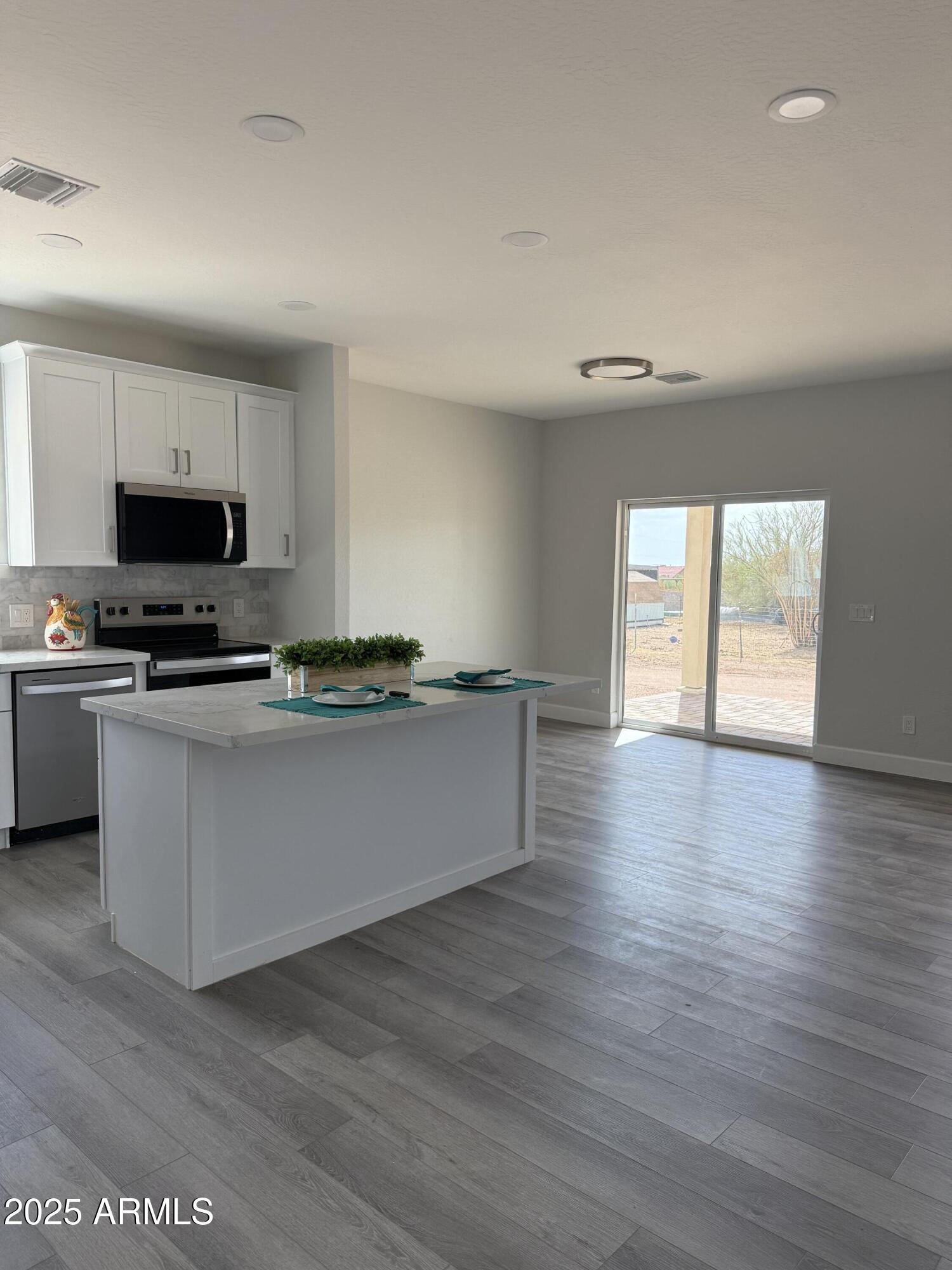 4294 North Wolverine Pass Road Apache Junction, AZ 85119 - Photo 11 of 37 a room with wooden floors and white walls