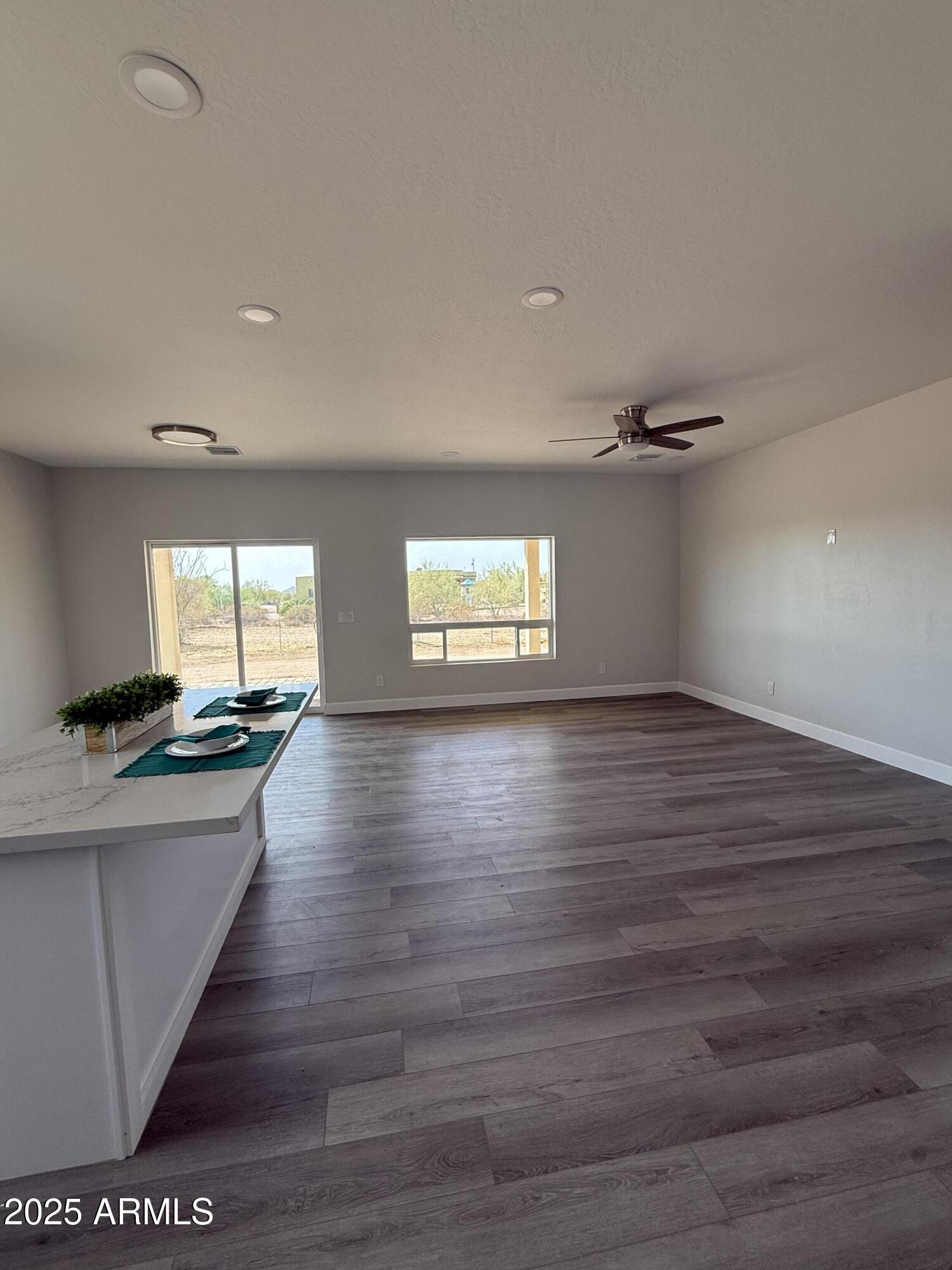 4294 North Wolverine Pass Road Apache Junction, AZ 85119 - Photo 12 of 37 a view of empty room with wooden floor and fan