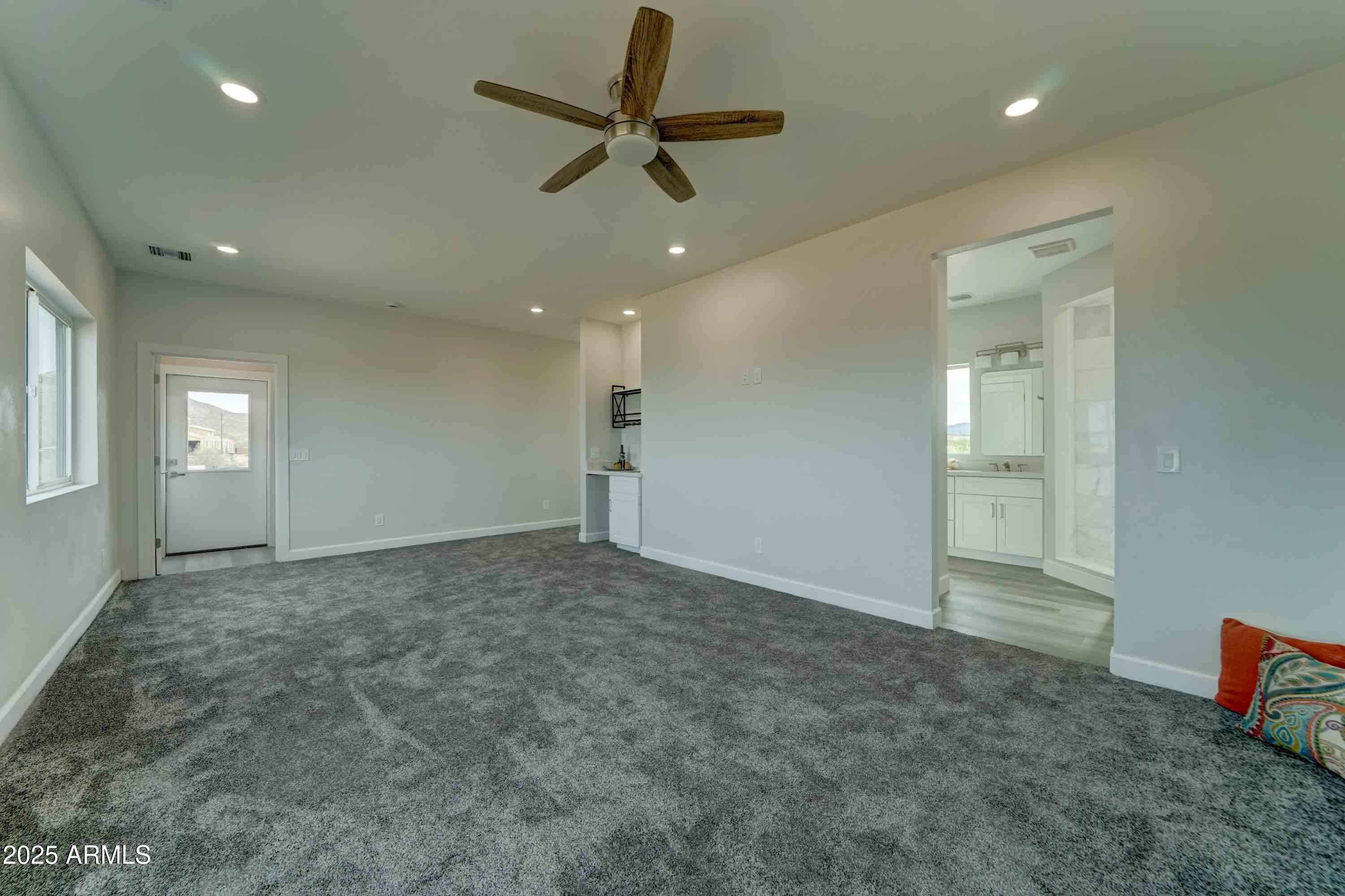 4294 North Wolverine Pass Road Apache Junction, AZ 85119 - Photo 16 of 37 an empty room with fan and windows