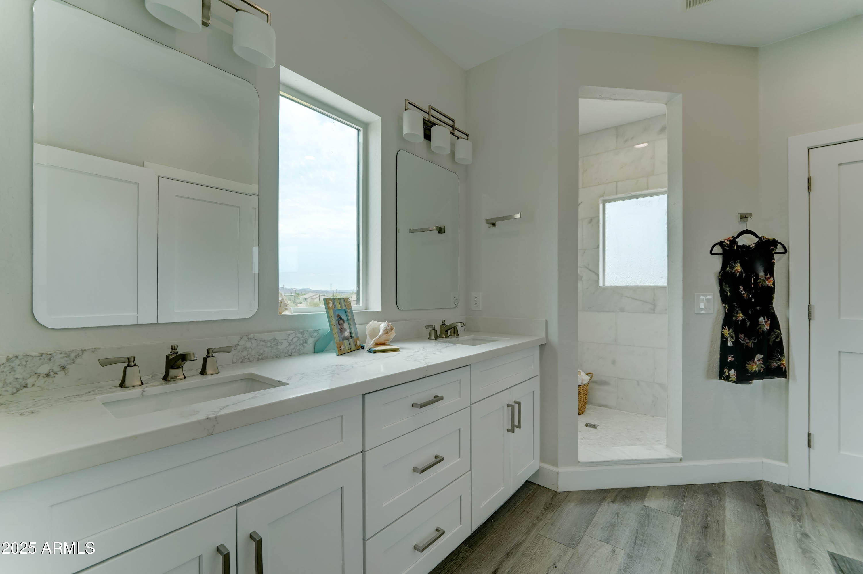 4294 North Wolverine Pass Road Apache Junction, AZ 85119 - Photo 17 of 37 a bathroom with a double vanity sink and mirror with shower