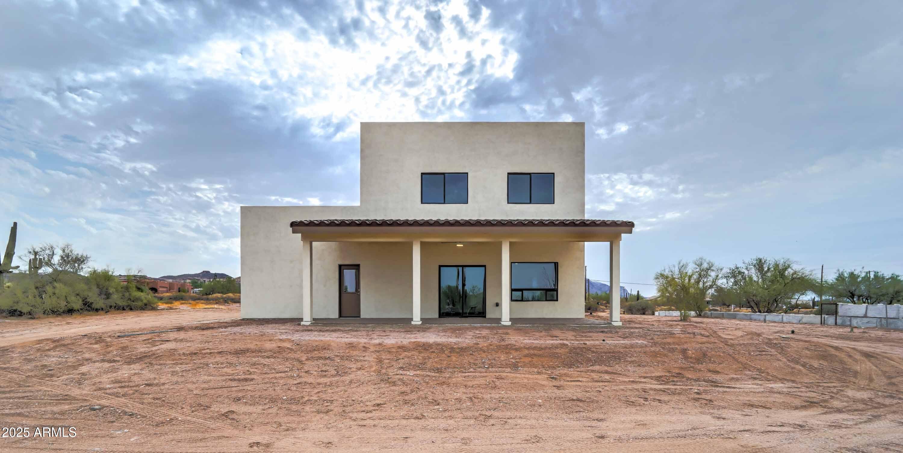 4294 North Wolverine Pass Road Apache Junction, AZ 85119 - Photo 33 of 37 a front view of a house with a yard and garage