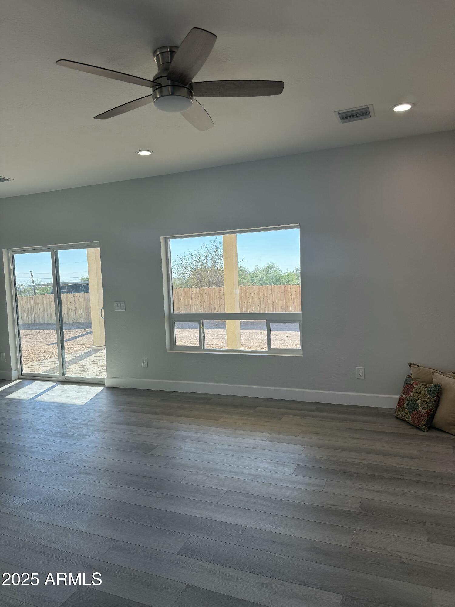4294 North Wolverine Pass Road Apache Junction, AZ 85119 - Photo 5 of 37 a view of an empty room with wooden floor and a window