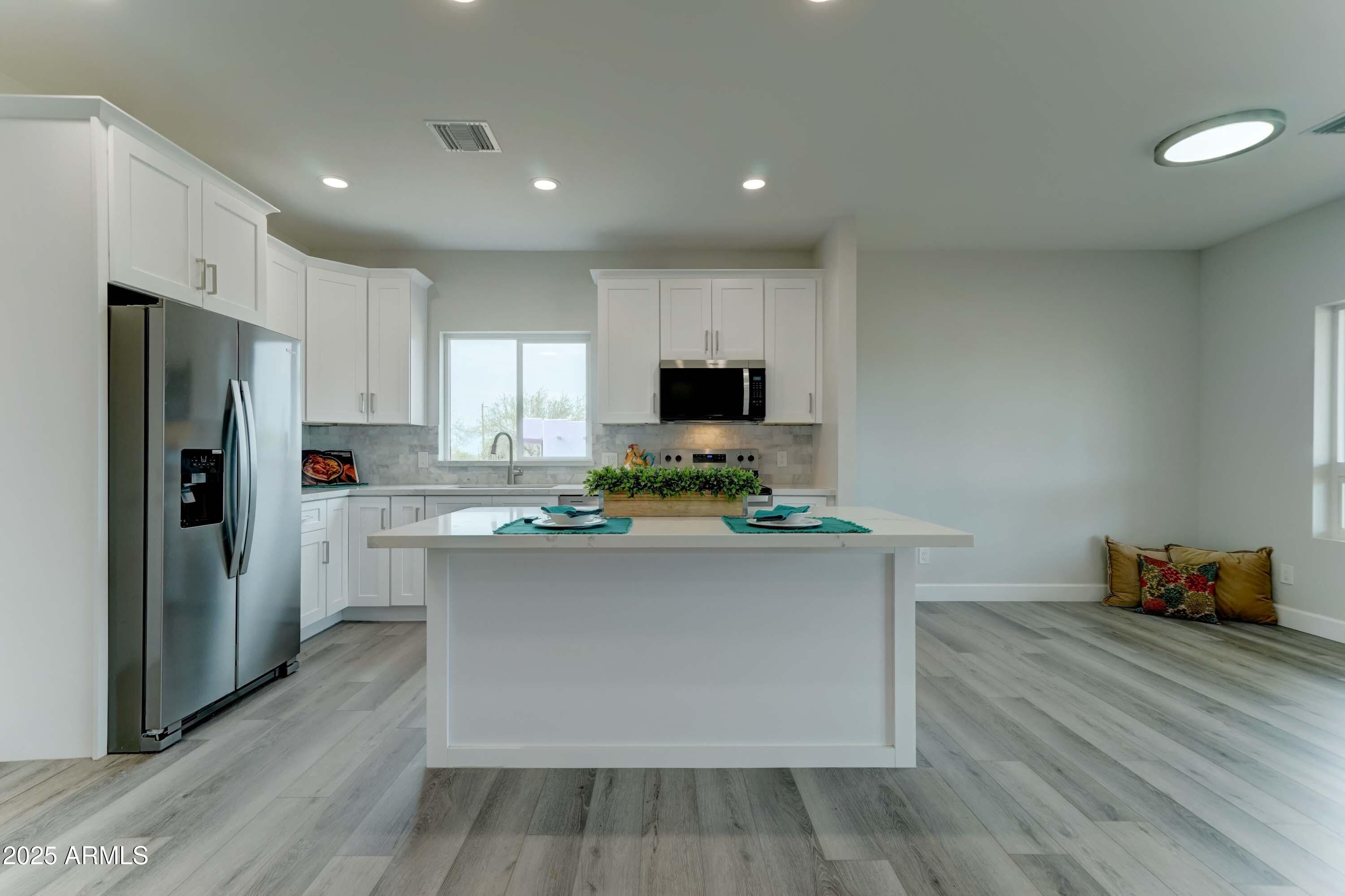 4294 North Wolverine Pass Road Apache Junction, AZ 85119 - Photo 7 of 37 a kitchen with stainless steel appliances a stove refrigerator and microwave