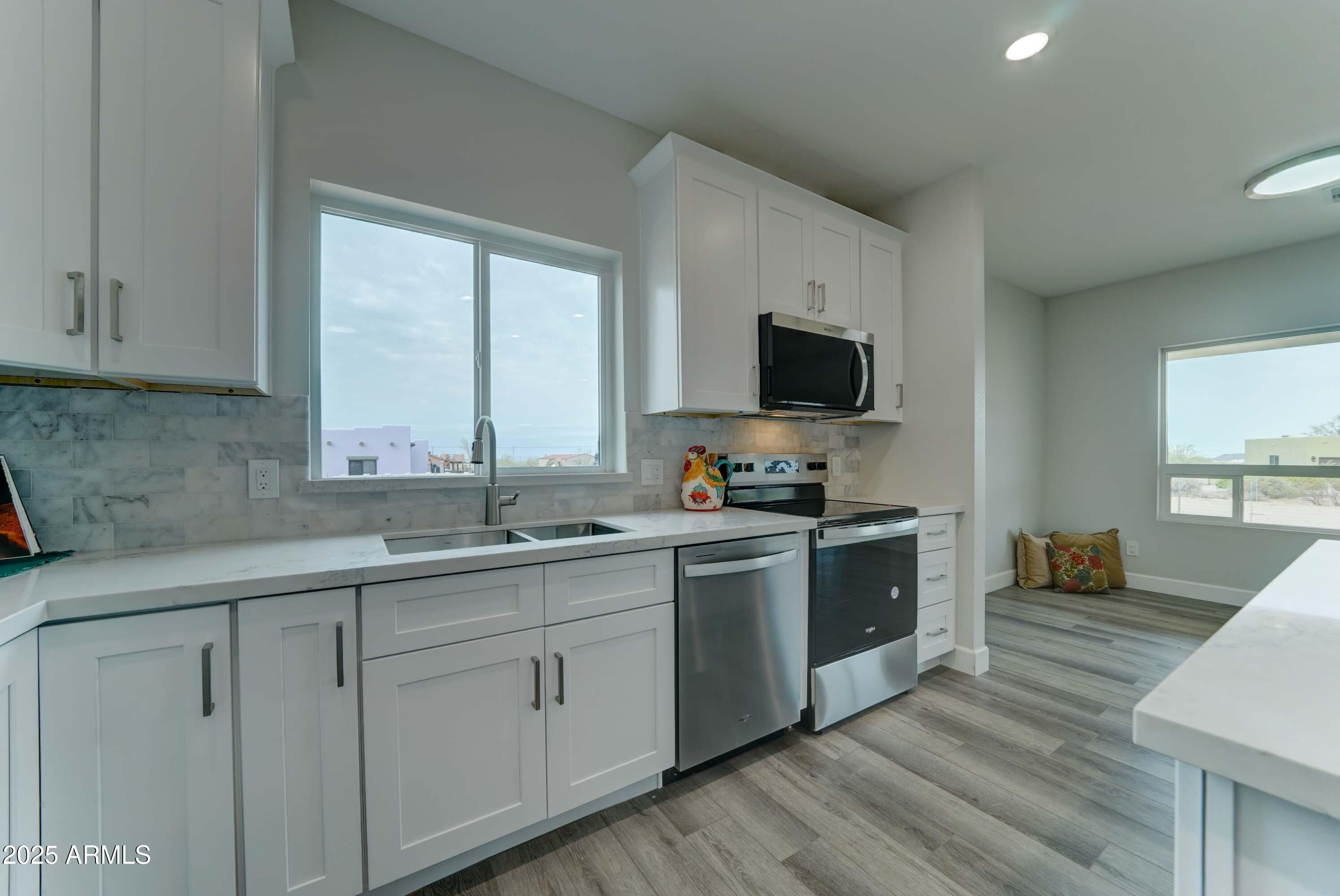 4294 North Wolverine Pass Road Apache Junction, AZ 85119 - Photo 8 of 37 a kitchen with a sink stove and cabinets