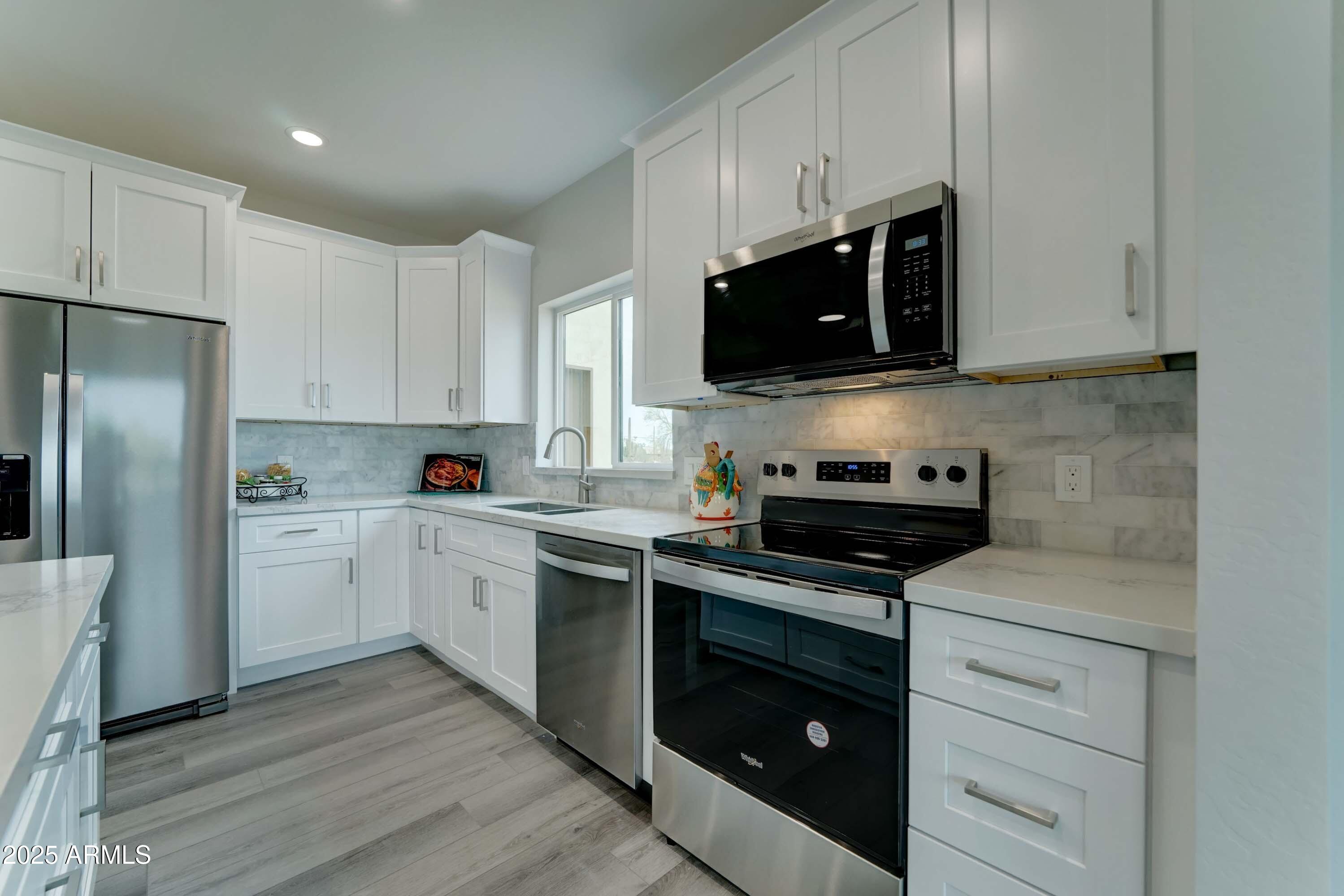 4294 North Wolverine Pass Road Apache Junction, AZ 85119 - Photo 9 of 37 a kitchen with cabinets stainless steel appliances and a counter space
