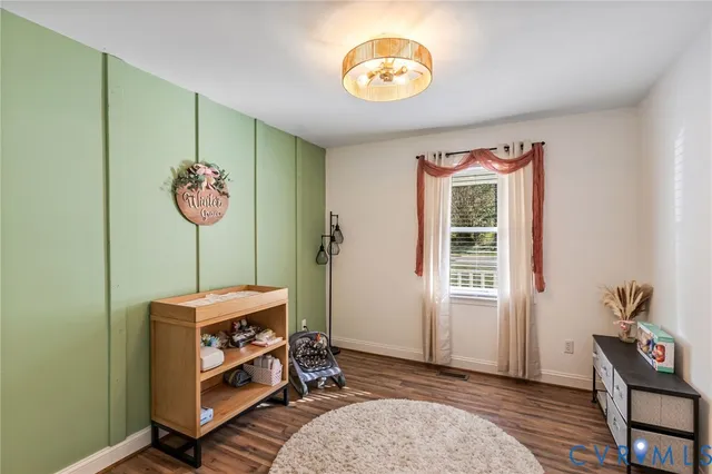 a view of room with furniture and wooden floor