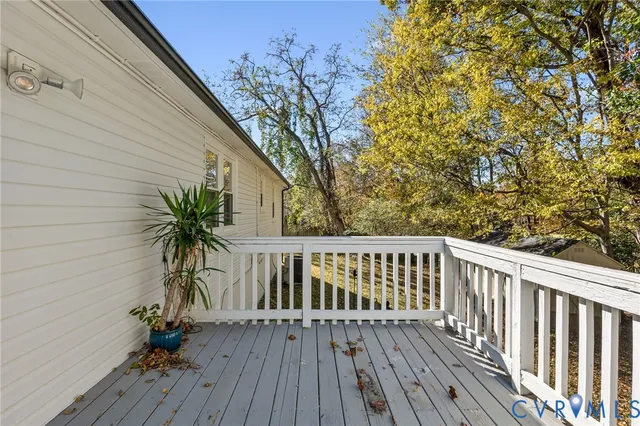 a view of balcony with wooden floor and fence
