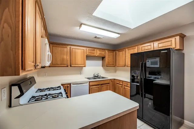 a kitchen with a stove a refrigerator and a sink