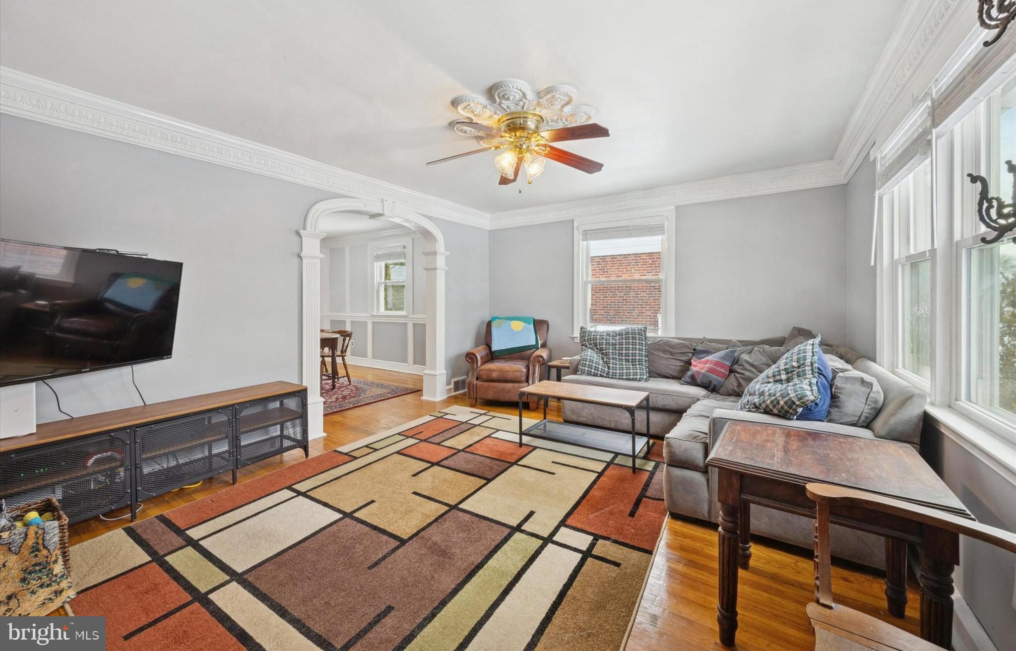 933 Greenbriar Lane Springfield, PA 19064 - Photo 3 of 20 a living room with furniture a flat screen tv and a window
