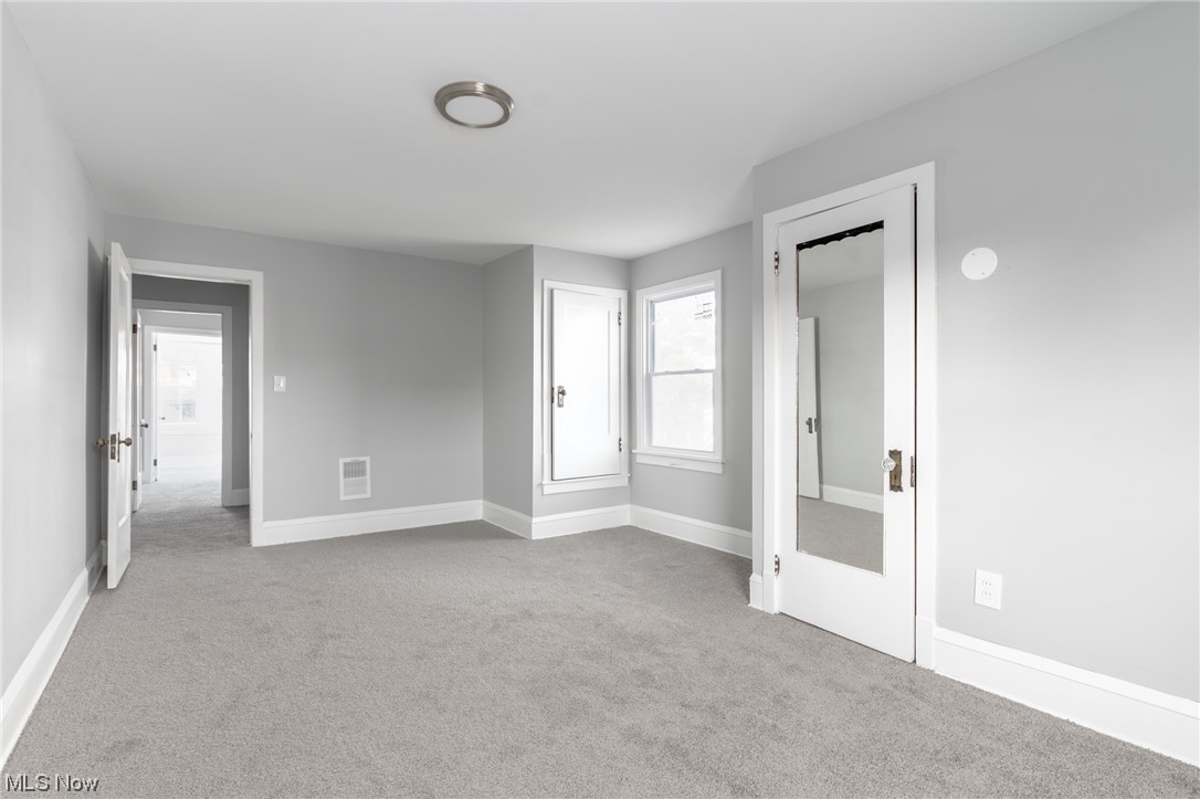1228 Melbourne Road Cleveland, OH 44112 - Photo 13 of 35 Empty room featuring light colored carpet