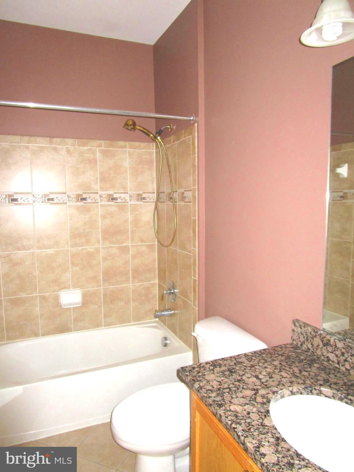 14204 Derby Ridge Road Bowie, MD 20721 - Photo 11 of 27 a bathroom with a granite countertop sink and a mirror