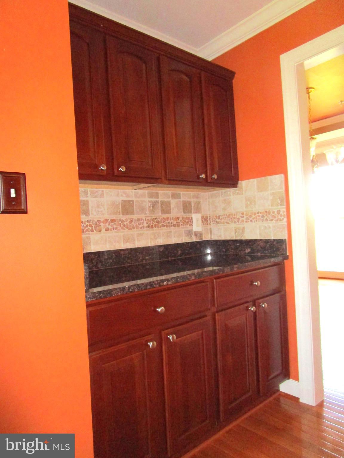 14204 Derby Ridge Road Bowie, MD 20721 - Photo 5 of 27 a kitchen with granite countertop wooden cabinets a sink and dishwasher