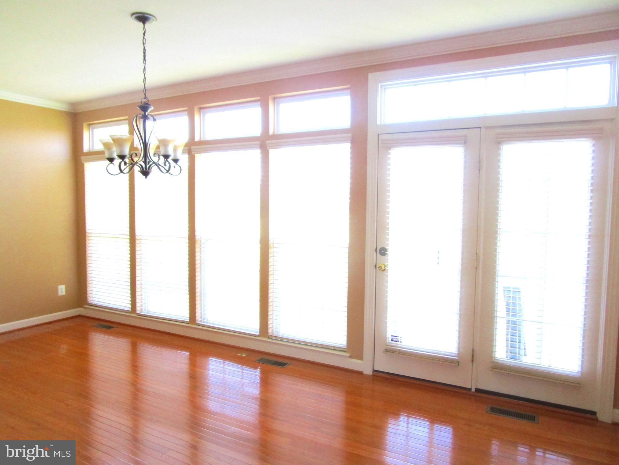 14204 Derby Ridge Road Bowie, MD 20721 - Photo 6 of 27 a view of empty room with wooden floor and fan