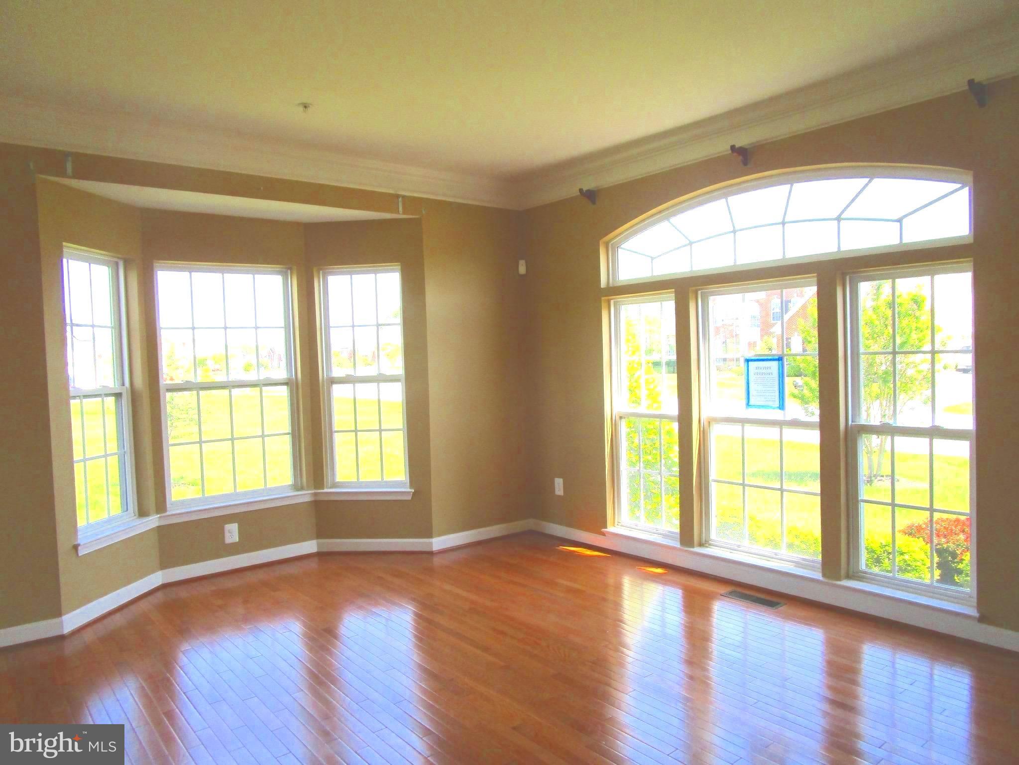 14204 Derby Ridge Road Bowie, MD 20721 - Photo 8 of 27 a view of an empty room with wooden floor and a window